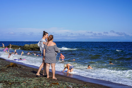 Vladivostok, Russia-July 12, 2020: Seascape with people on a glass beach. A local landmarkのeditorial素材