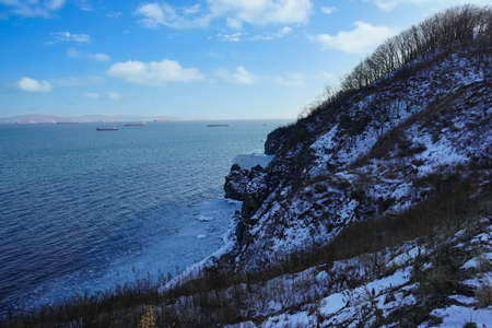 Seascape with a view of the bay with ships and a rock.の写真素材