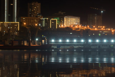 Vladivostok, Russia. Urban landscape with silhouettes of houses and light from lanterns.のeditorial素材