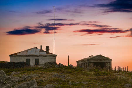 Old abandoned buildings on the background of the sunset. Cape Pospelova, Primorsky Kraiの写真素材