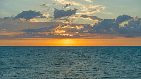 Colorful bright sunset on the background of the seascapeの写真素材