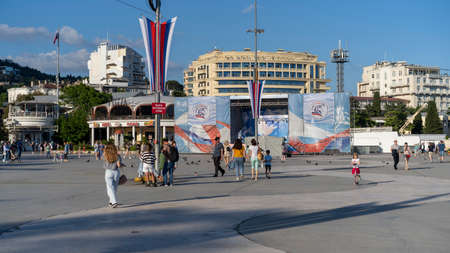 YALTA, Crimea-June 12, 2021: Urban landscape with a view of the embankment. People are walking by the sea.のeditorial素材