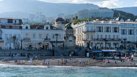 YALTA, Crimea-June 12, 2021: Urban landscape with a view of the embankment. People are walking by the sea.のeditorial素材