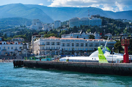 Yalta, Crimea-June 11, 2021: Seascape with a pleasure ship on the background of Yaltaのeditorial素材
