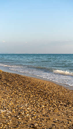 Seascape with a pebble beach.の写真素材