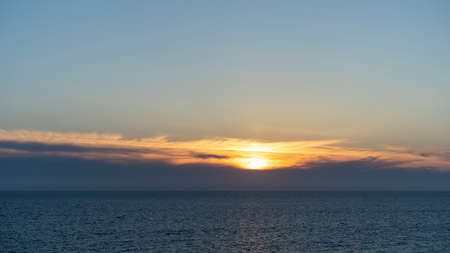 seascape with a beautiful sunset on the background of the sea.の写真素材