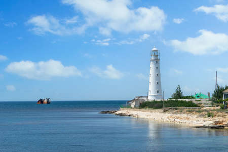 Seascape with a view of the white lighthouse on Cape Tarkhankut, Crimeaの写真素材
