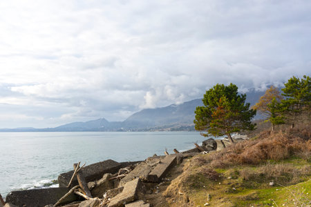 Seascape with a destroyed building near the shore.