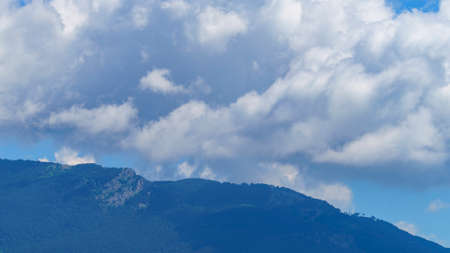 Mountain landscape with white clouds in the sky.の写真素材