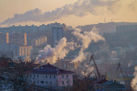 Urban landscape with smoke from heating systems. Vladivostok, Russiaの写真素材