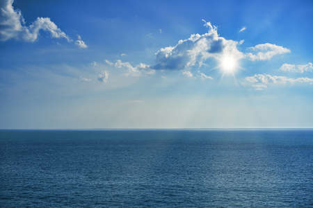 Seascape with a beautiful blue sky and rays of the sun.の写真素材