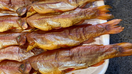 Natural background with smoked trout close-up