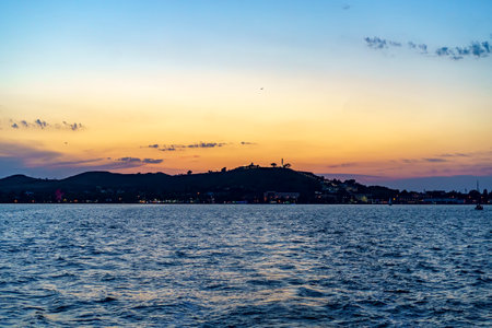 Seascape with a view of the silhouette of the city of Kerch at sunset. Crimea, Russiaの写真素材