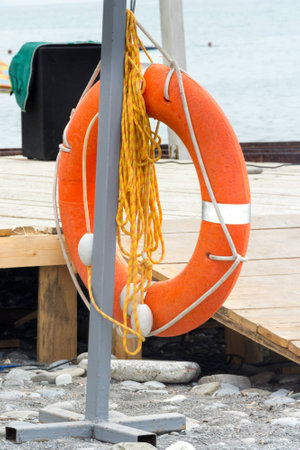 lifebuoy orange color at the beachの写真素材