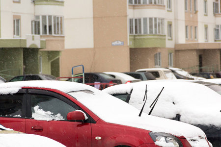 cars in the yard covered with snowの写真素材