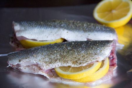 fish seabass and sliced lemonの写真素材