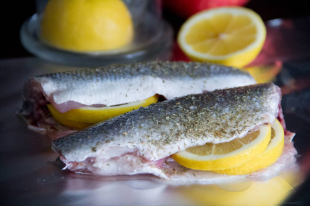 fish seabass and sliced lemonの写真素材