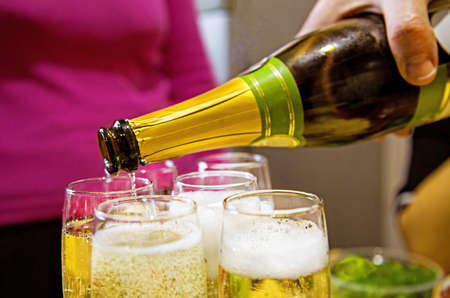 Pouring champagne at home, new year and christmas  party for friends and familyの写真素材