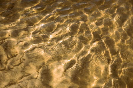 Underwater sand. Water reflection pattern. Sunny water light pattern
