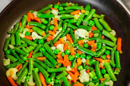 Mexican mixed vegetables on a frying pan. Top view vegan diet ingredients. Keto dish. Homemade healthy food.の写真素材