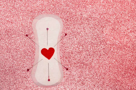 Menstrual pain cramps, gynecological concept. Pms and Premenstrual dysphoric disorder syndrome conception. Woman periods and intimate hygiene pink background.の写真素材