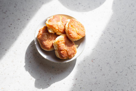 Russian sweet baked food. Fried pancakes on black modern pan close up.