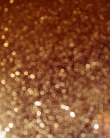 Vertical photo orange festive bokeh background. Blurred defocused golden glitter background.