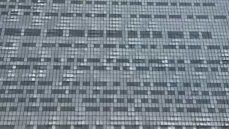A modern contemporary glass building facade beautifully showcasing intricate geometric patterns and...