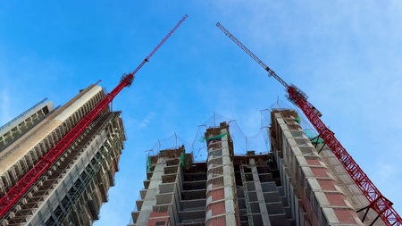 A captivating and stunning view of construction featuring cranes and skyscrapers set against a...