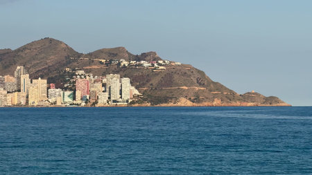 A breathtaking view showcasing a vibrant seaside city adorned with modern architecture and an...