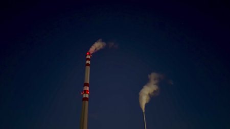 Smoke from chimneys highlights environmental impact and energy production, raising awareness on...