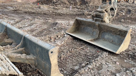Heavy machinery equipment can be observed at an active construction site, showcasing a variety of...
