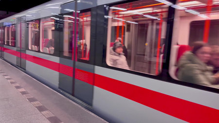 A vibrant and energetic subway train in swift motion, showcasing commuters and the essence of modern...