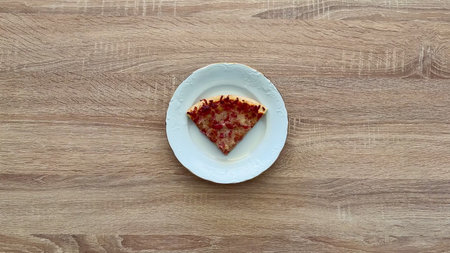 A delicious, mouthwatering slice of pizza presented gracefully on a delicate plate, ideal for...
