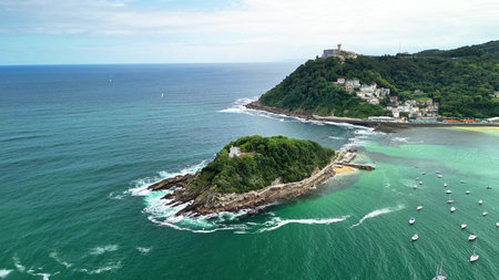 This breathtaking aerial view captures a coastal island that is beautifully surrounded by stunning...