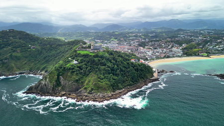 A stunning aerial shot beautifully reveals a vibrant coastal area adorned with lush greenery and a...