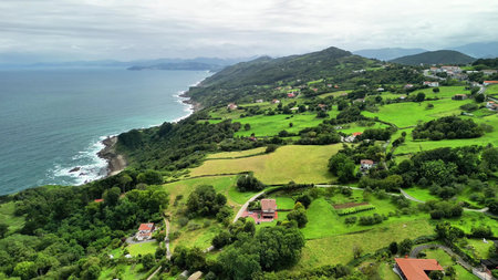 Stunning and breathtaking aerial views that showcase lush green hills alongside a serene and...