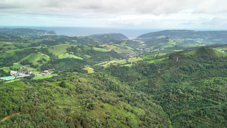 A breathtaking aerial landscape beautifully showcasing lush green hills and a stunning coastline...