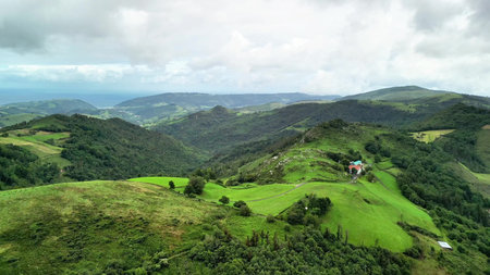 Experience stunning aerial views of rolling green hills and clouds, highlighting natures amazing...