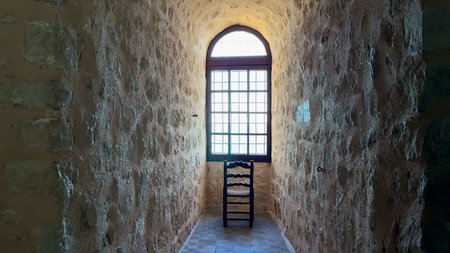 A peaceful and serene stone hallway is beautifully illuminated by soft natural light, showcasing a...