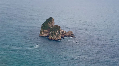 An aerial shot captures the stunning beauty of a picturesque island, surrounded by tranquil ocean...