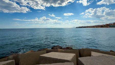 A stunning coastal landscape painting a beautiful picture of tranquil waters alongside dramatic...