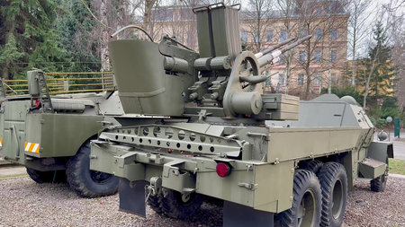 Here is a comprehensive and detailed view of a military vehicle that prominently features an...