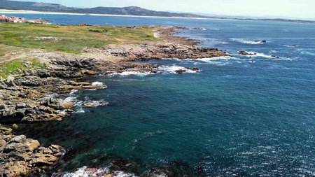 Experience stunning aerial views of rugged coastlines merging with crystalclear blue waters, inviting explorationの写真素材