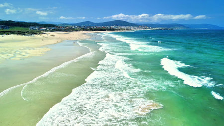Experience the breathtaking and stunning beauty of a beach featuring azure waves and soft sandy shoresの写真素材