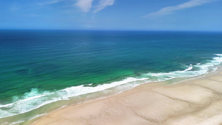 Experience breathtaking aerial shots showcasing vibrant waters and pristine sandy shores along a stunning coastlineの写真素材