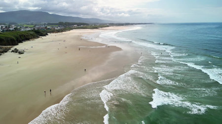 Captivating aerial footage beautifully showcasing a stunning beach along with gentle and calming waves rolling inの写真素材