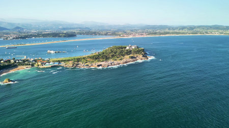 An absolutely stunning aerial view showcasing a picturesque coastal island beautifully surrounded by turquoise watersの写真素材