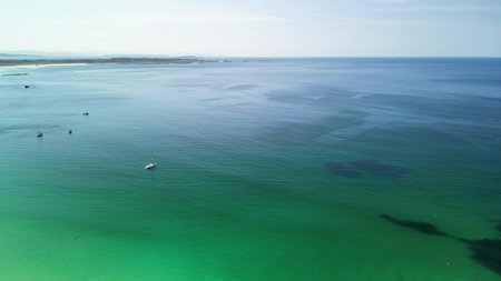 Stunning aerial footage beautifully capturing the vibrant turquoise ocean waves beneath a perfectly...