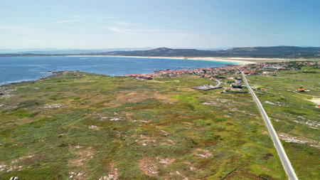 Breathtaking aerial perspective of a serene coastal area with vibrant greenery and clear blue waters.の写真素材